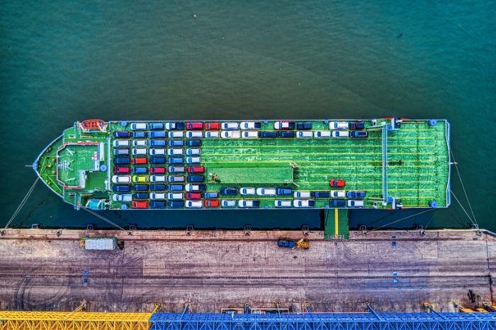 Shai-Hulud V2 Poses Risk To NPM Supply Chain A high-level shot of a cargo ship containing many car.