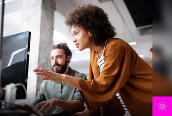A women pointing towards a screen in how to use DSPM for operations