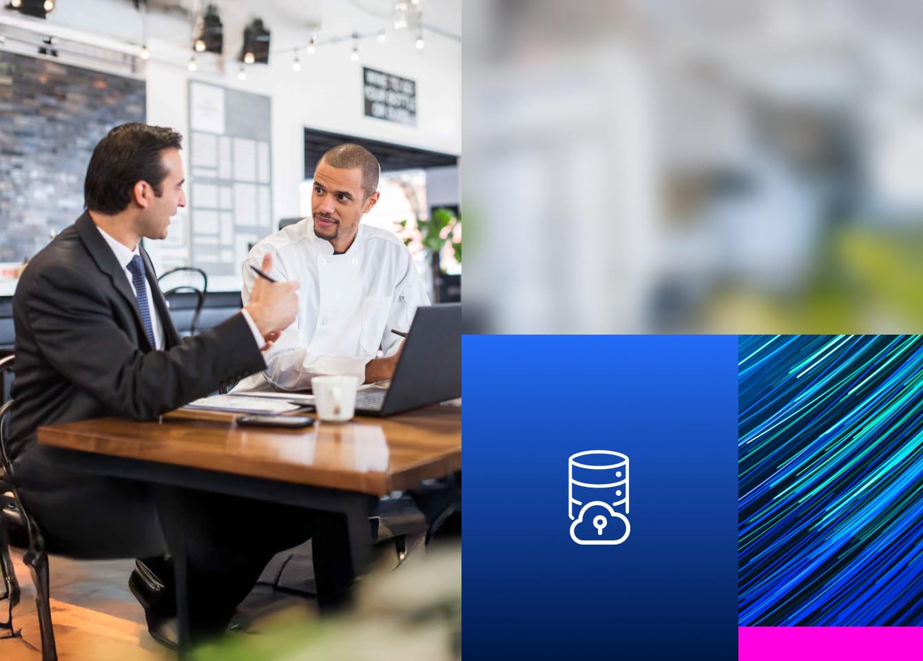 Two men sitting at a laptop discussing data security posture management