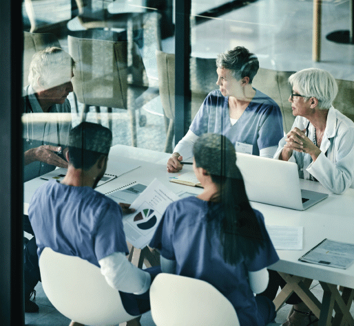 Clinicians reviewing hospital records in a conference room