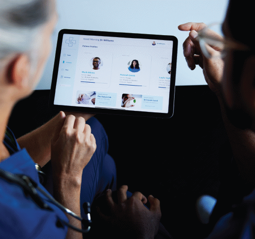 A doctor reviews patient data on an ipad